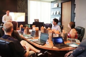 Business professional presenting to team in modern office meeting room